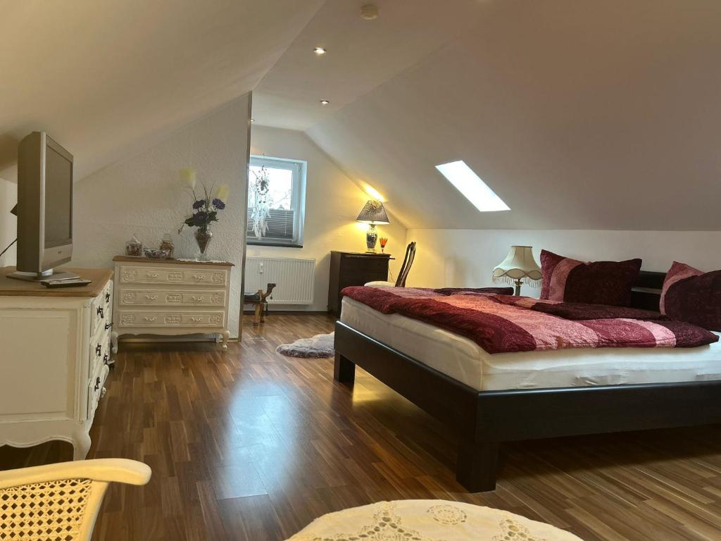 a bedroom with a bed and a dresser and a television at Vintage Traum in Hückelhoven