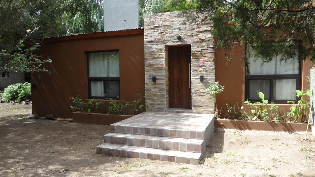 a house with a door and stairs in front of it at Las Toribias II in El Rincón