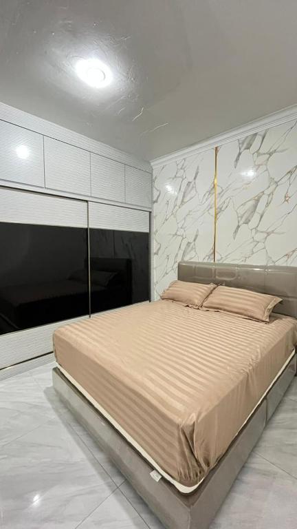a bedroom with a large bed in a room at Jati Homestay Batam Center in Batam Center