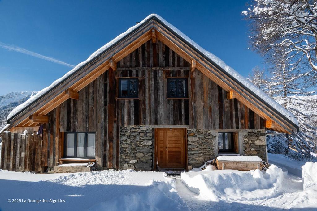 a log cabin in the snow in the winter at La Grange des Aiguilles in Albiez-le-Jeune