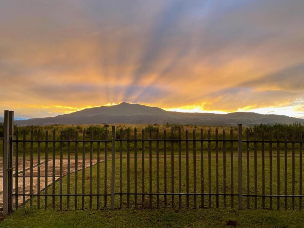 a fence with a mountain in the background at Eindelik on de Lange in Graskop