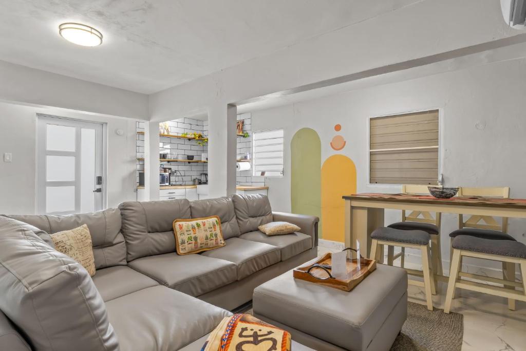 a living room with a couch and a table at Perfect Group Retreat for 10 Near Beach & Airport in Carolina
