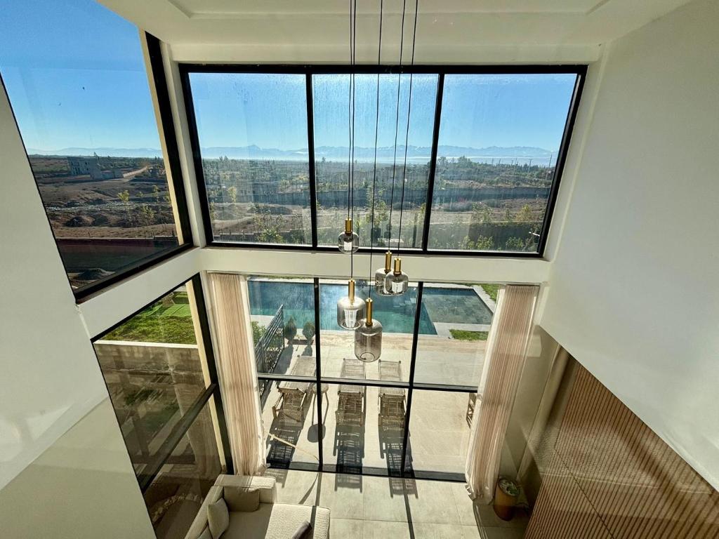 a room with a large window and a chandelier at Luxury Villa Lam atlas view in Marrakesh