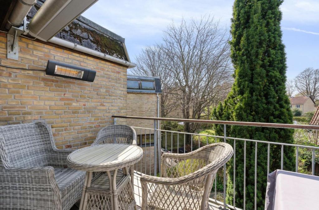 a patio with chairs and a table on a balcony at Balcony Apartment - Lyngby Great Copenhagen in Kongens Lyngby