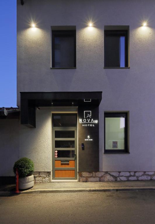 a building with a door with a sign on it at Hotel NOVA Inn Sarajevo in Sarajevo