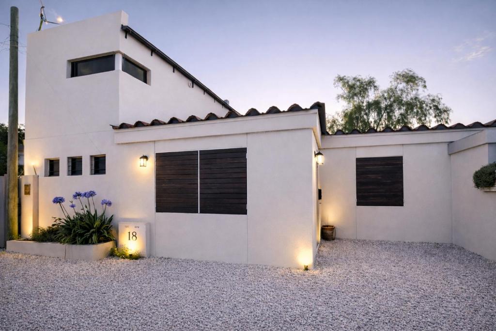 a white house with a driveway at Hornero House in San Antonio de Areco