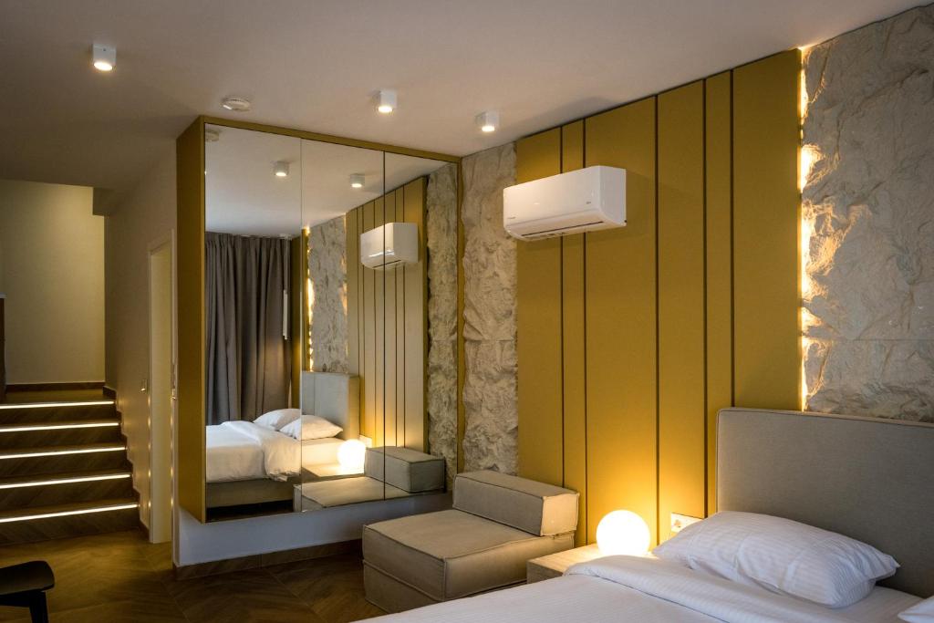 a hotel room with a bed and a mirror at City Breeze Suites in Heraklio