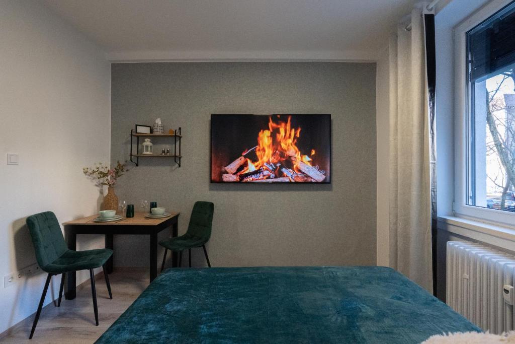 a bedroom with a bed and a fire on the wall at Wittgruber's Upperroom in Koliba