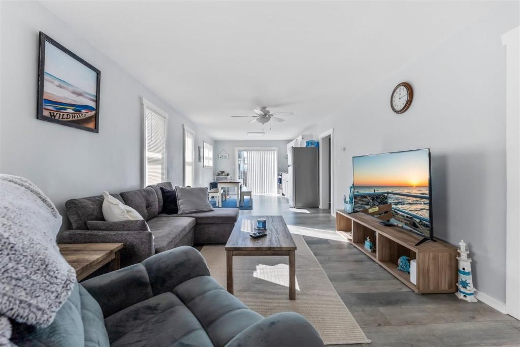 a living room with a couch and a tv at 404 W Maple Ave, Unit A in Wildwood