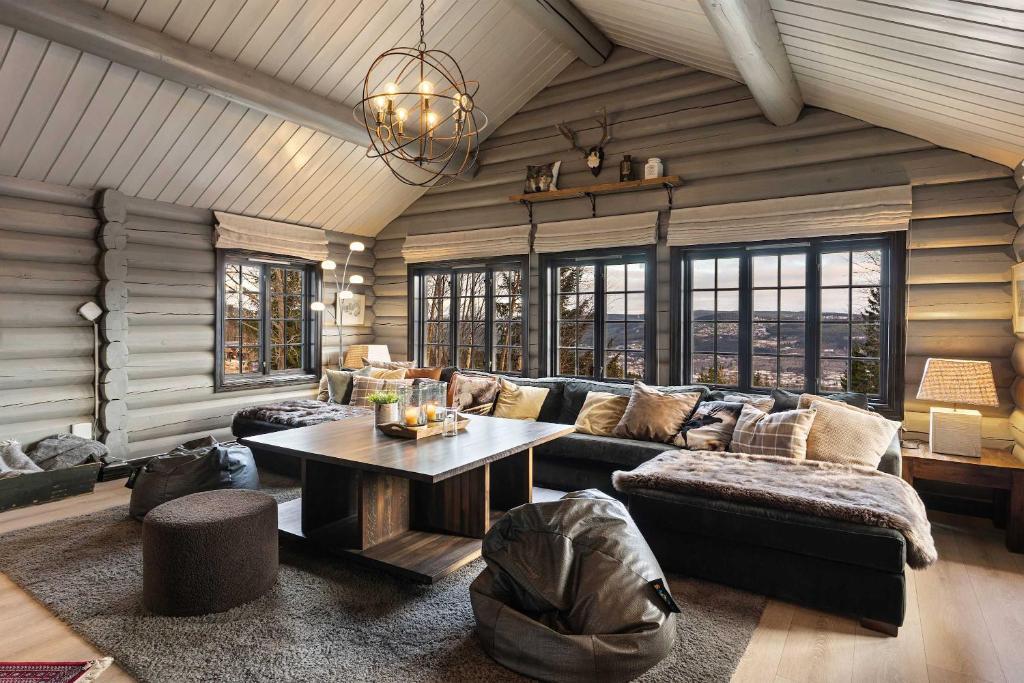 a living room with a couch and a table at TH590- Large ski-in out chalet with jacuzzi, sauna in Trysil in Trysil