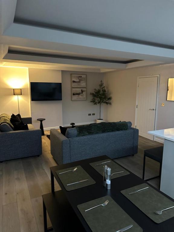 a living room with two couches and a table at Riverview Apartment 2 in Matlock