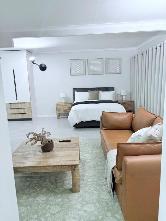 a living room with a bed and a couch at Canopy stay 4 in Sandton