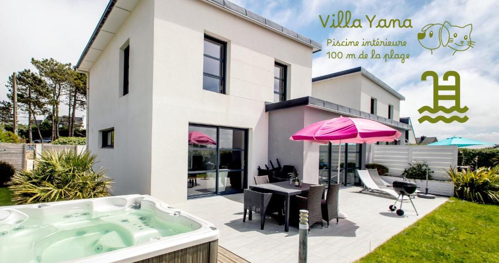 a jacuzzi tub in the backyard of a house at Villa Yana Bretagne Piscine Intérieure partagée et Spa Privatif 100m de la Plage in Sibiril