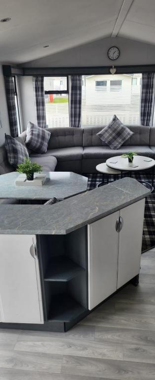 a kitchen and living room with a couch and a table at Trecco Bay Private rentals in Newton
