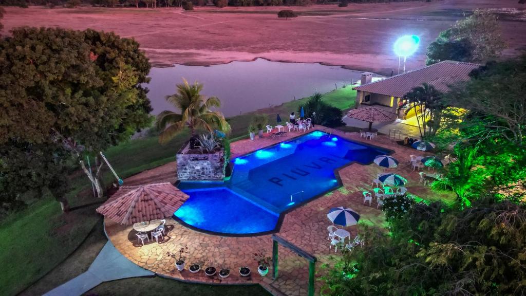 an overhead view of a swimming pool at night at Pousada Piuval in Tapa