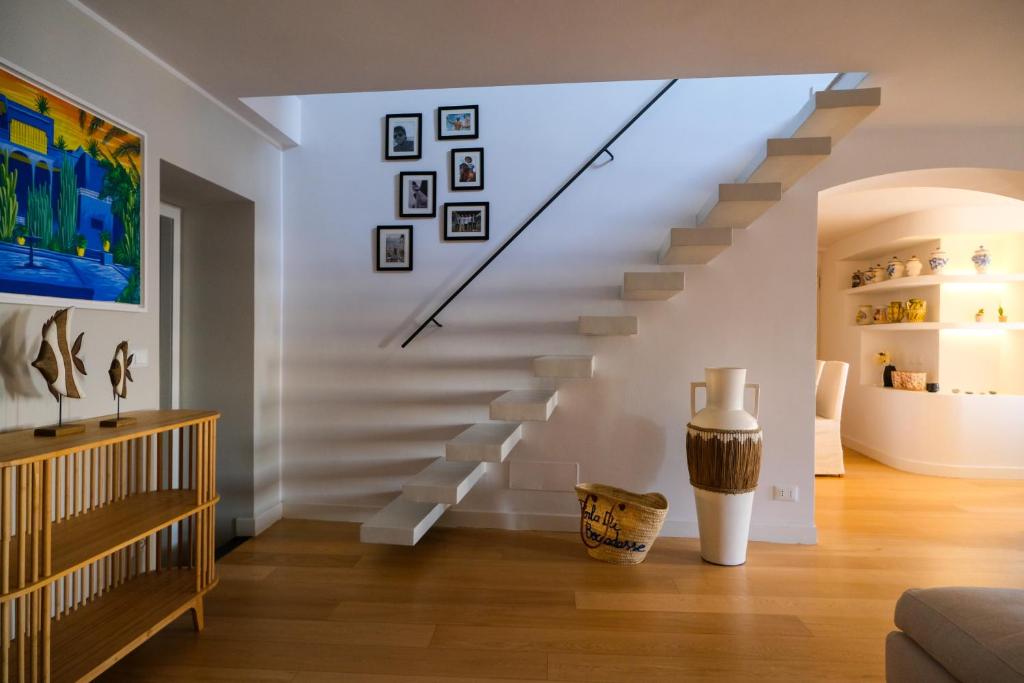 a living room with a staircase in a house at La Perla di Boccadasse in Genoa