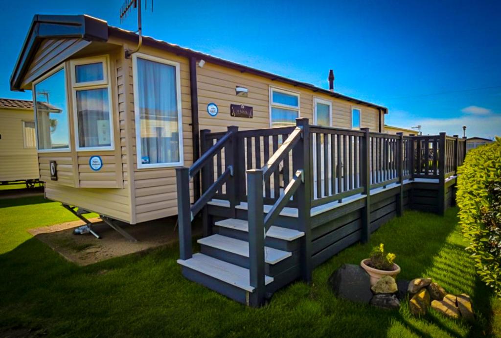 a tiny house with a staircase in a yard at K&S at 1529 in Selsey