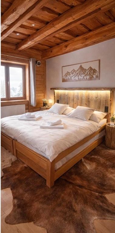 a bedroom with a large bed in a room at Apartmány Starý mlyn in Habovka