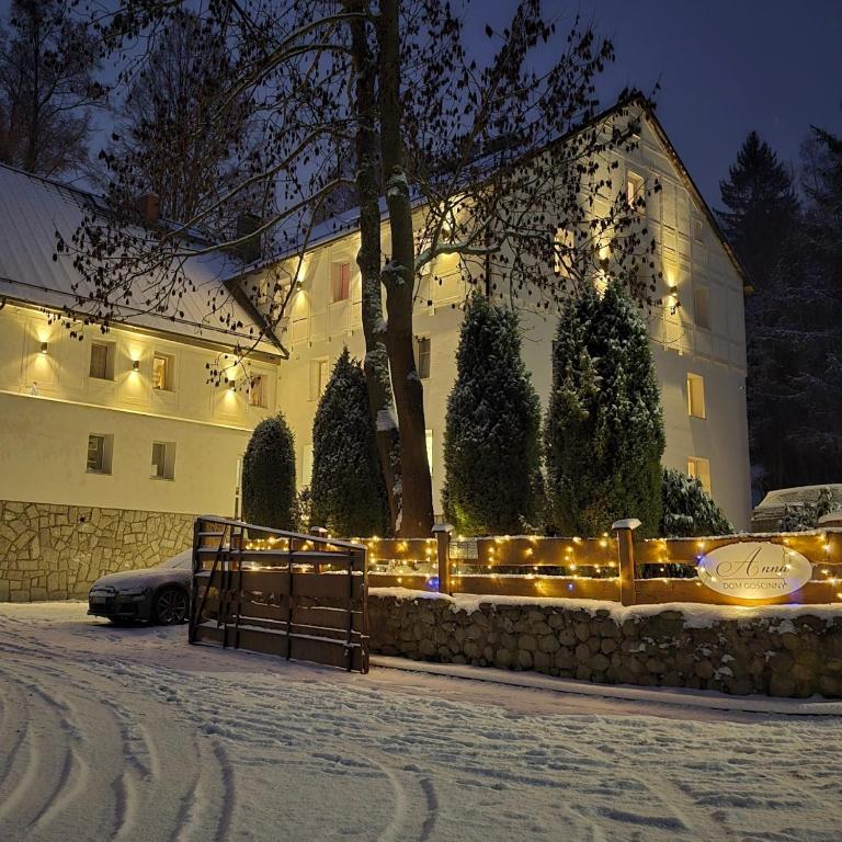 a building with christmas lights in front of it at Anna in Miłków