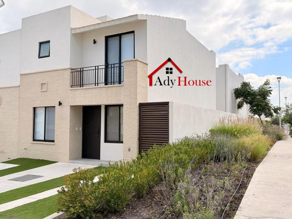 a large white building with a red ally house at AdyHouse Ziré in Buena Vista