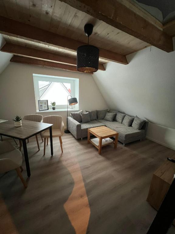 a living room with a couch and a table at Auental in Husum