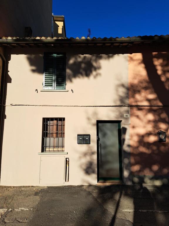 a white building with a door and a window at Borgo Piccolo in Imola