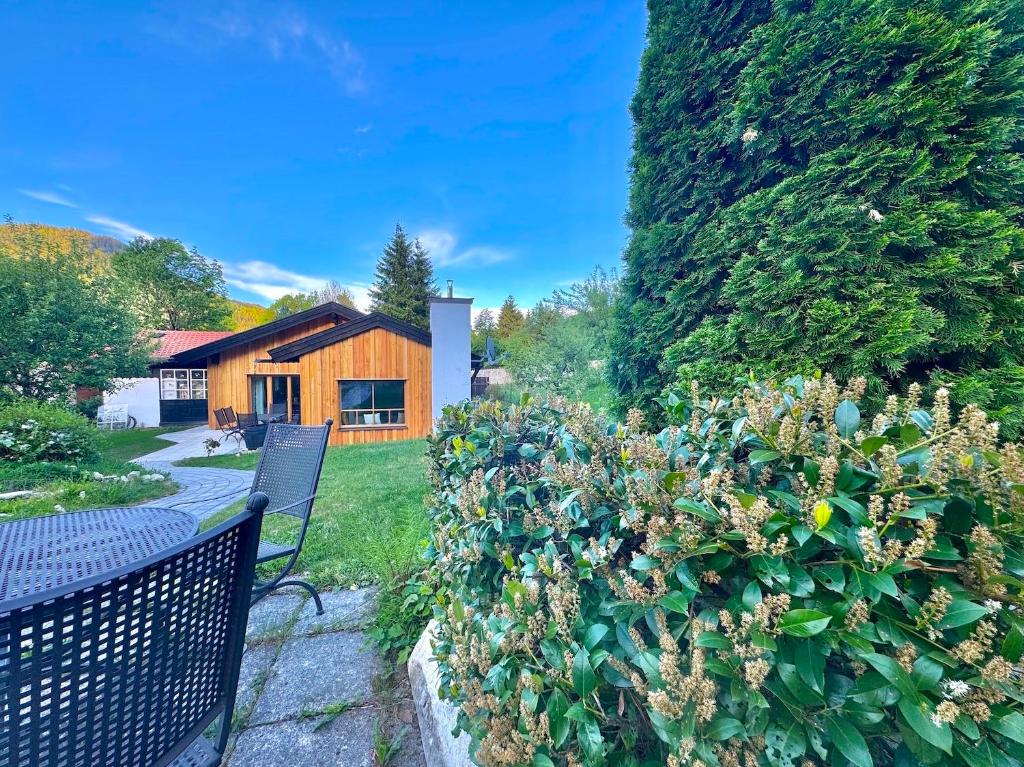a garden with two benches and a house at Ferienhaus "Bodenschneid" am Schliersee in Schliersee