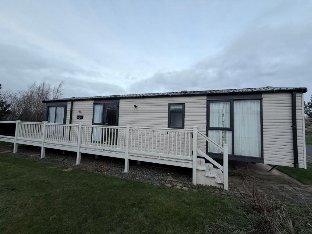 a mobile home with a porch and a deck at RelaxDream in Port Seton