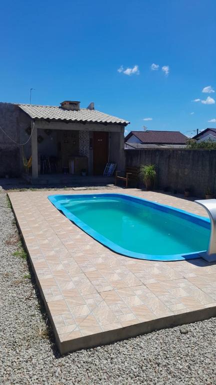 a swimming pool in front of a house at Casa Ana y Ángelo in Pântano Grande