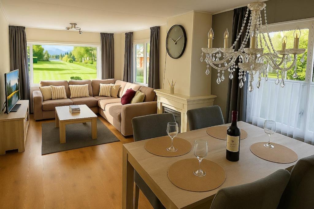 a living room with a table with wine glasses on it at Moonlight Nature Holiday Home in Westergeest