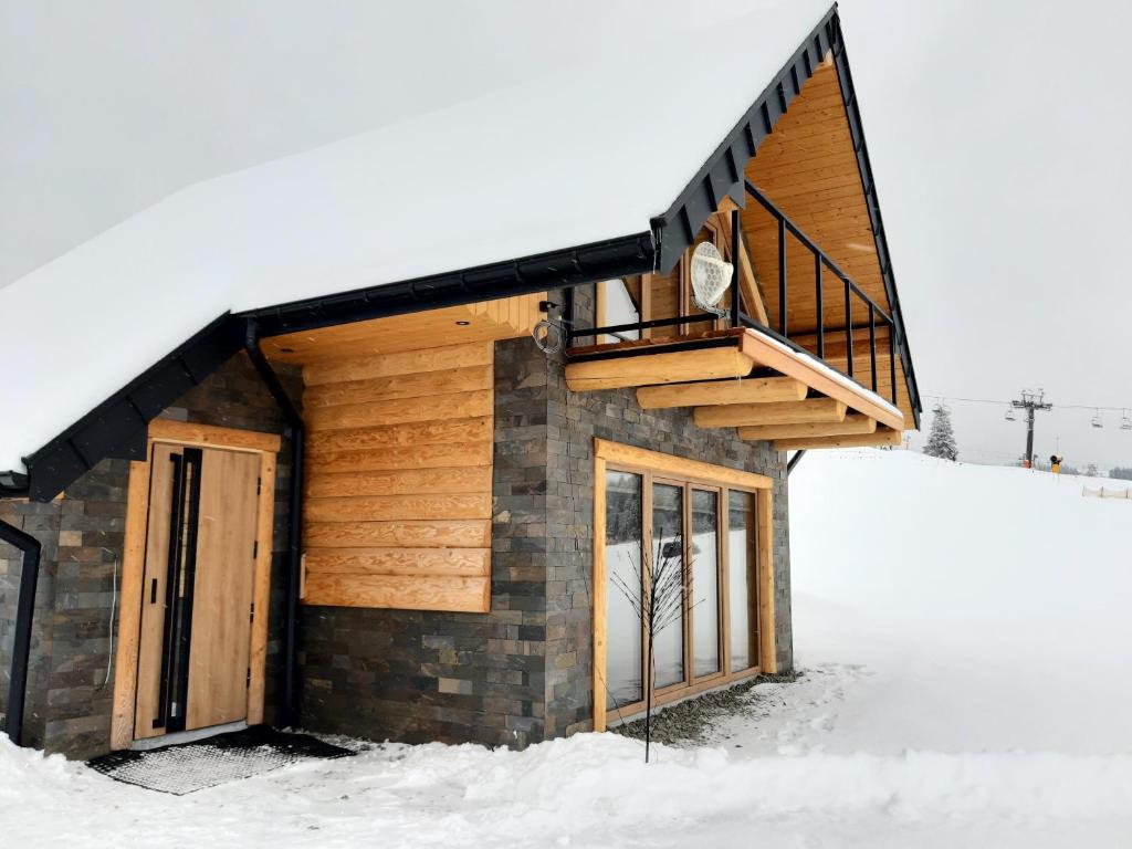a small house in the snow with a staircase at Koziniec ski & chill in Czarna Góra