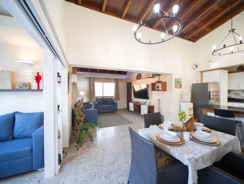 a living room with a table and a blue couch at Colonial 2BR Apartment 2 mins walk to beach in Sosúa
