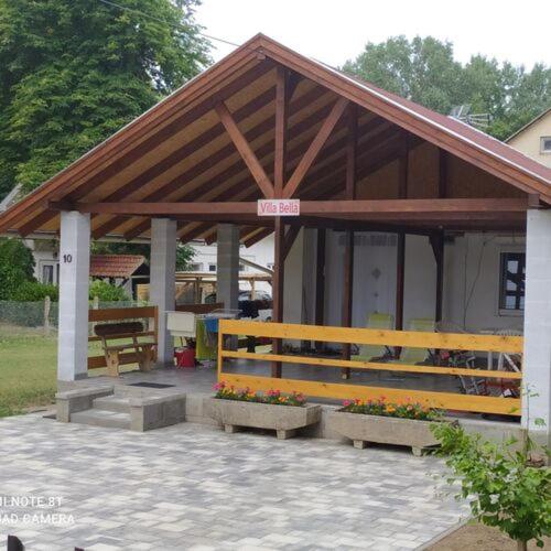 a pavilion with benches and flowers in front of it at Villa Bella in Szántód