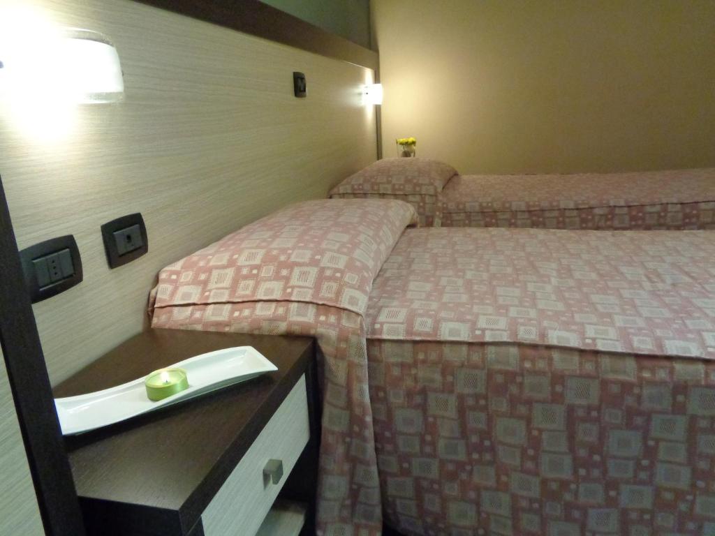 Postel nebo postele na pokoji v ubytování Hotel Airone
