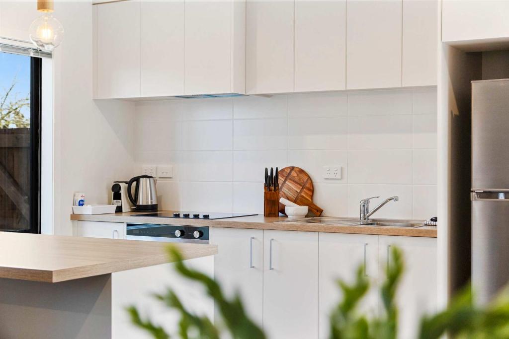 a kitchen with white cabinets and a sink at Relaxed Stay in Modern Comfort - By Superior Stays in Hamilton