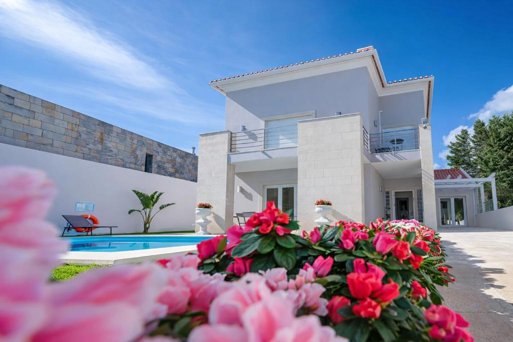 a villa with a swimming pool and pink flowers at Sintra Dream Garden Villa near Cascais in Sintra