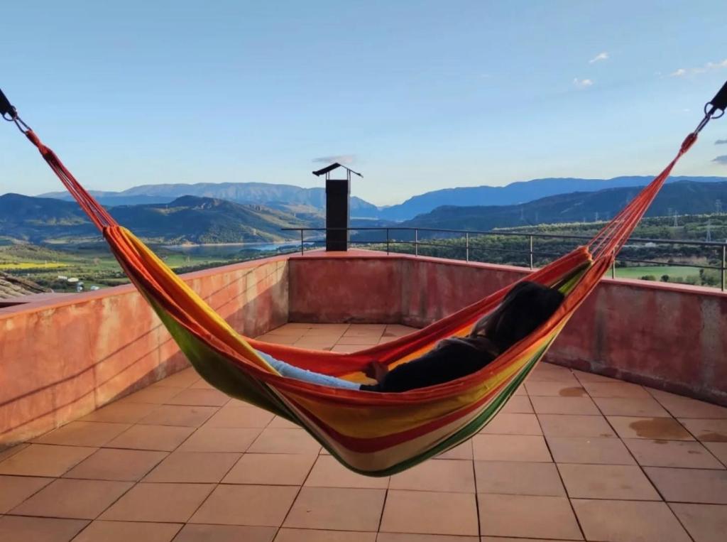 a hammock on a roof with a view at Casa Escola in La Pobla de Segur