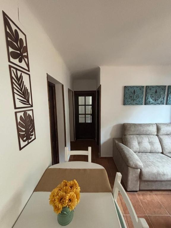 a living room with a table and a couch at El Castaño in Guisando