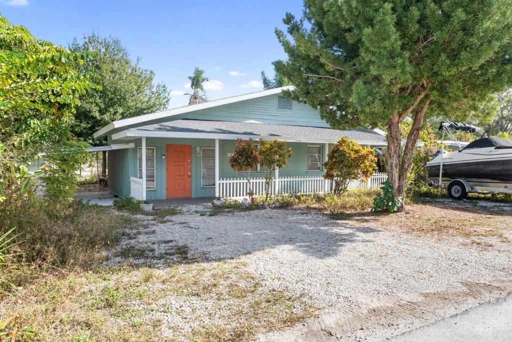 a house with a car parked in front of it at House - Minutes from Siesta Key! in Sarasota