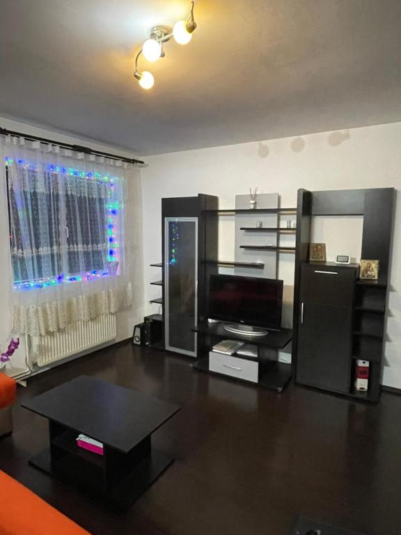 a living room with a television and a table at Apartament ALEX in Sibiu