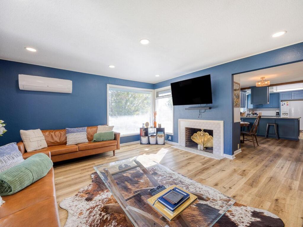 a living room with a couch and a fireplace at The Nest with Firepit & Backyard Oasis in Klamath Falls