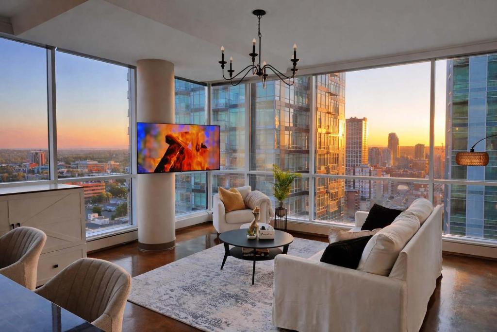 a living room with a view of a city at Summit Mountain & Skyline Views Beltline in Calgary