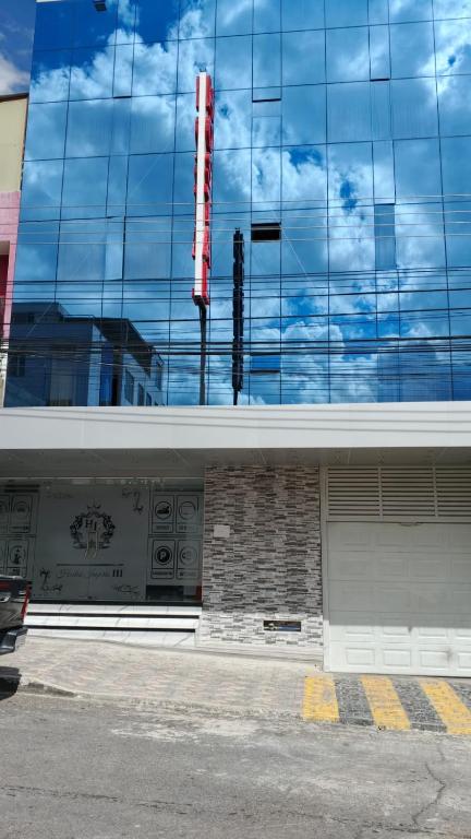 a building with a sign on the side of it at Hostal Imperio la Kennedy in Quito
