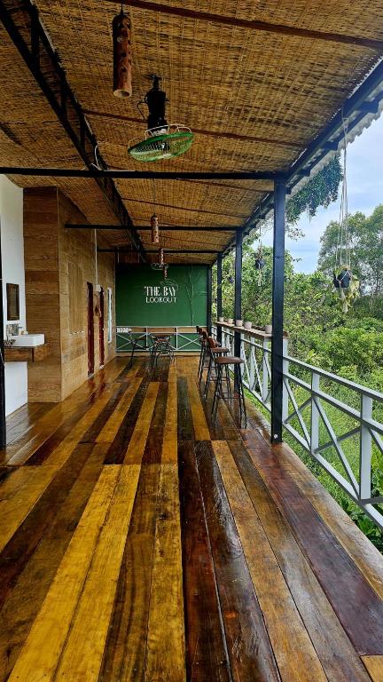 an empty room with a green sign on a bridge at The Bay Lookout in Kaôh Rŭng (3)