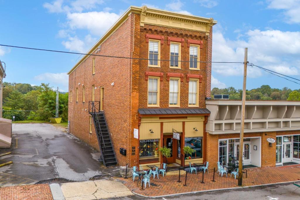 a brick building with tables and chairs in front of it at Moore on Main in Abingdon