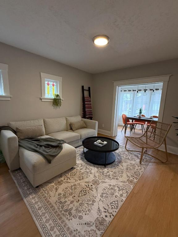 a living room with a couch and a table at A home in Niagara falls- The Maple and Mist in Niagara Falls