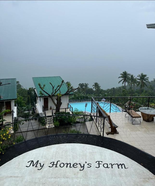 a sign that reads my flowers farm in front of a pool at My Honey's Farm in Nangkaan
