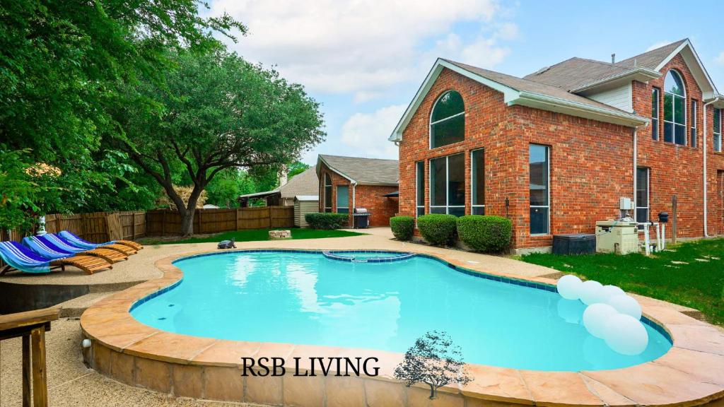 a swimming pool in front of a house at Captivating 6BR 3B Home with Pool & Fire Pit in Mesquite
