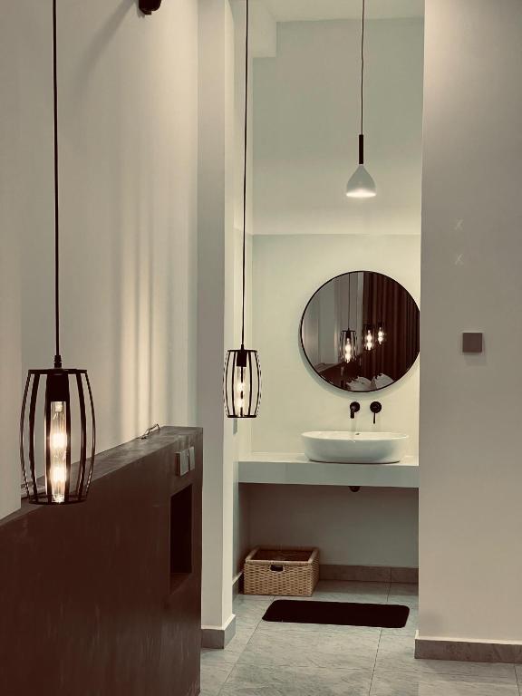 a bathroom with a sink and a mirror at LaRoy -Mirissa in Mirissa