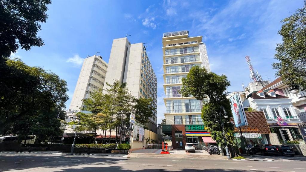 a group of tall buildings in a city at Tebu Hotel Bandung in Bandung
